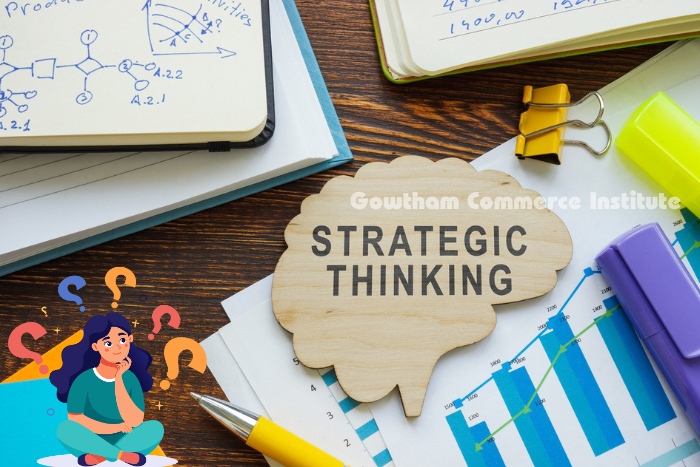 Wooden brain-shaped cutout labeled 'Strategic Thinking' on a desk with charts, notebooks, and stationery, symbolizing the focus on strategic thinking skills at Gowtham Commerce Institute in Peelamedu, Coimbatore